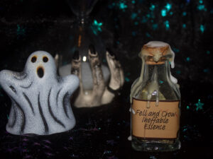 A product photo of a spell jar with the label "Fell and Crow Ineffable Essence" in the right background is a ceramic ghost and hourglass.